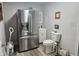 Bathroom adjacent to kitchen features a toilet, sink, and stainless steel refrigerator at 1515 Renee Dr, Plainfield, IN 46168