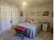 A carpeted bedroom has an updated light fixture and gray patterned curtains and bedding at 1515 Renee Dr, Plainfield, IN 46168