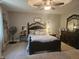 A primary bedroom features a decorative ceiling fan, an area rug and a carved bed frame with matching furniture at 1515 Renee Dr, Plainfield, IN 46168