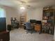 Bedroom featuring a ceiling fan, bookshelves, desk, and carpeted floors at 1515 Renee Dr, Plainfield, IN 46168