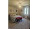 A carpeted bedroom has an updated light fixture and gray patterned curtains and bedding at 1515 Renee Dr, Plainfield, IN 46168