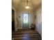 A well-lit foyer with wood floors, modern lighting, a charming decor, and a decorative front door at 1515 Renee Dr, Plainfield, IN 46168