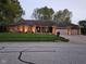 Charming single-story brick home with well-manicured lawn and exterior lighting at 1515 Renee Dr, Plainfield, IN 46168