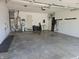 Spacious garage with a garage door, water heater, shelving and ample space for vehicles and storage at 1515 Renee Dr, Plainfield, IN 46168