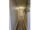 Hallway with neutral paint, wood flooring, and decoratively framed artwork and mirrors at 1515 Renee Dr, Plainfield, IN 46168