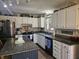Bright kitchen with white cabinets, granite counters, and modern stainless steel refrigerator at 1515 Renee Dr, Plainfield, IN 46168
