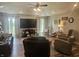 A spacious living room features hardwood floors, ceiling fan, large TV, recessed lighting, and comfortable seating at 1515 Renee Dr, Plainfield, IN 46168