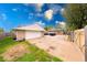 Backyard with a detached garage and spacious driveway/ parking area, and the back of the house at 2150 Main St, Beech Grove, IN 46107