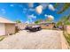 Spacious gravel backyard, detached garage, car trailer, and partially covered car at 2150 Main St, Beech Grove, IN 46107