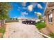 Spacious gravel backyard with detached garage and partially covered car with vehicle trailer at 2150 Main St, Beech Grove, IN 46107