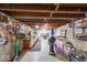 Spacious basement workshop area with wooden beams, work benches, and ample storage at 2150 Main St, Beech Grove, IN 46107
