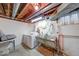 Basement laundry area with white washer and dryer, utility sink, and painted brick walls at 2150 Main St, Beech Grove, IN 46107