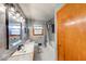 Bathroom with gray tile, updated lighting, and a shower/tub combination at 2150 Main St, Beech Grove, IN 46107