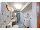 Bathroom with a blue color scheme, includes a toilet, sink, medicine cabinet, and small white dresser at 2150 Main St, Beech Grove, IN 46107