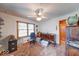 Room featuring vintage furniture, patterned carpet, a window, and ceiling fan at 2150 Main St, Beech Grove, IN 46107