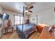 Cozy bedroom featuring a four-poster bed, ceiling fan, and natural light from the window at 2150 Main St, Beech Grove, IN 46107