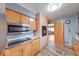 Kitchen with wood cabinets and brick accent wall at 2150 Main St, Beech Grove, IN 46107