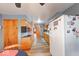 Galley kitchen with wood cabinets, white appliances, and wood-look flooring at 2150 Main St, Beech Grove, IN 46107