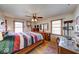 Bedroom with wooden floors, four-poster bed, and multiple windows at 2150 Main St, Beech Grove, IN 46107