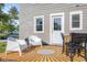 Inviting back patio with chairs, table, and stylish rug, perfect for outdoor entertaining at 2336 Sycamore St, Columbus, IN 47201