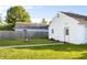 Spacious backyard featuring a fire pit, detached garage, well-kept lawn, and privacy fence at 2336 Sycamore St, Columbus, IN 47201