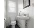 Bathroom featuring toilet, sink, modern faucet, stylish mirror and window at 2336 Sycamore St, Columbus, IN 47201