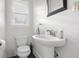 Bathroom featuring toilet, sink, modern faucet, stylish mirror and window at 2336 Sycamore St, Columbus, IN 47201