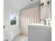 Bright bathroom features toilet, shower with curtain, and stylish sink with modern faucet at 2336 Sycamore St, Columbus, IN 47201