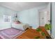 Cozy bedroom with hardwood floors, pastel walls and a bright window at 2336 Sycamore St, Columbus, IN 47201