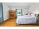 Cozy bedroom with hardwood floors, natural light, and soft blue curtains at 2336 Sycamore St, Columbus, IN 47201
