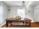 Dining room features a large wood table, modern chairs, sheer curtains, and a pendant light fixture at 2336 Sycamore St, Columbus, IN 47201