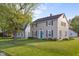 Traditional two-story home on a well-maintained lawn, surrounded by mature trees in a suburban neighborhood at 2336 Sycamore St, Columbus, IN 47201