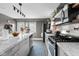 Well-lit kitchen with marble counter tops, stainless appliances, and gray cabinetry at 2336 Sycamore St, Columbus, IN 47201