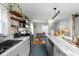 Bright kitchen with stainless appliances and a marble breakfast bar and eat-in dining area at 2336 Sycamore St, Columbus, IN 47201
