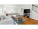 Cozy living room featuring hardwood floors, a sectional sofa, stylish decor and a large window at 2336 Sycamore St, Columbus, IN 47201