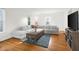 Bright living room featuring hardwood floors, large windows, a sectional sofa, and stylish decor at 2336 Sycamore St, Columbus, IN 47201