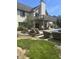 Landscaped backyard with lounge chairs, patio, and a house featuring a balcony overlooking the pool at , Shelbyville, IN 46176