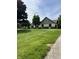 Manicured lawn with mature trees highlights the home's exterior at , Shelbyville, IN 46176