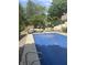 In-ground pool with cover and surrounding patio furniture, with a view of the backyard at , Shelbyville, IN 46176