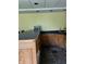 Finished basement wet bar with sleek black countertops and oak cabinets at , Shelbyville, IN 46176