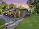 Charming brick ranch home featuring a wooden back deck and gravel surroundings at 2548 N Letterman Rd, Paragon, IN 46166
