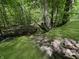 Picturesque backyard features a stream, natural foliage and a rock-lined bank at 2548 N Letterman Rd, Paragon, IN 46166