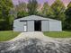 Large silver barn with a gravel driveway and a sliding door at 2548 N Letterman Rd, Paragon, IN 46166