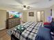 A well-lit bedroom is presented with a comfortable bed and dresser offering lots of storage at 2548 N Letterman Rd, Paragon, IN 46166