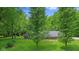 Beautifully landscaped property with a view of the house framed by mature trees and greenery at 2548 N Letterman Rd, Paragon, IN 46166