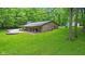 Charming brick home with covered porch, nestled in a lush green landscape with mature trees at 2548 N Letterman Rd, Paragon, IN 46166
