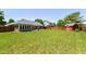 Expansive backyard showcasing a manicured lawn, shed, mature trees, and a home with a brick sunroom at 3126 Oakmont Dr, Lapel, IN 46051