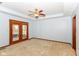 Spacious bedroom with neutral carpet and double doors leading to a screened porch at 3126 Oakmont Dr, Lapel, IN 46051