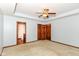 Spacious bedroom with ensuite bathroom, ceiling fan, and neutral carpet at 3126 Oakmont Dr, Lapel, IN 46051