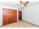 Carpeted bedroom features a double-door closet, wood trim, and an adjacent room at 3126 Oakmont Dr, Lapel, IN 46051